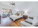 Bright bedroom with a comfortable bed, sitting area, wood floors, and serene water views at 751 34Th Ne Ave, St Petersburg, FL 33704
