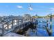 View of a private boat dock with a boat lift and an American flag on a sunny day at 751 34Th Ne Ave, St Petersburg, FL 33704