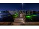 Night view of the boat dock, illuminated by green lights under a starlit sky at 751 34Th Ne Ave, St Petersburg, FL 33704