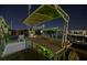 Boat dock featuring a lighted workstation on the water, lit with green lights at 751 34Th Ne Ave, St Petersburg, FL 33704