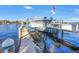 Dock featuring a boat with a boat lift on a sunny day and beautiful blue water in the background at 751 34Th Ne Ave, St Petersburg, FL 33704