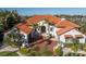 Mediterranean style home with a clay tile roof, arched entry, and mature tropical landscaping at 751 34Th Ne Ave, St Petersburg, FL 33704