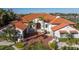 Elegant home featuring a red tile roof, arched entryway, mature landscaping, and brick driveway at 751 34Th Ne Ave, St Petersburg, FL 33704