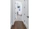 Hallway with hardwood floors and white doors leading to different rooms in the house at 751 34Th Ne Ave, St Petersburg, FL 33704
