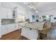 Gourmet kitchen with white cabinetry, granite countertops, and a large island perfect for entertaining at 751 34Th Ne Ave, St Petersburg, FL 33704