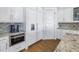 Elegant kitchen featuring granite countertops, stainless steel appliances, and custom white cabinetry at 751 34Th Ne Ave, St Petersburg, FL 33704