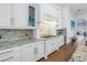 Kitchen featuring granite countertops, stainless steel appliances, white cabinets, and hardwood floors at 751 34Th Ne Ave, St Petersburg, FL 33704