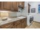 Well-organized laundry room featuring ample cabinetry, granite countertops, and modern washer and dryer at 751 34Th Ne Ave, St Petersburg, FL 33704