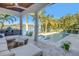 Covered patio with outdoor furniture overlooking a sparkling pool and lush tropical landscaping at 751 34Th Ne Ave, St Petersburg, FL 33704
