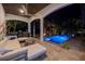 Covered lanai featuring an outdoor kitchen, outdoor seating and a beautiful, lit in-ground pool at 751 34Th Ne Ave, St Petersburg, FL 33704
