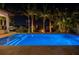 Evening view of a luxury pool and spa with fire pit and outdoor lighting among tropical foliage at 751 34Th Ne Ave, St Petersburg, FL 33704