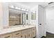 Well-lit bathroom featuring an ample vanity with lots of storage and a shower with neutral toned walls at 831 Maple Ct # 303, Dunedin, FL 34698