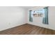 Serene bedroom with wood-style flooring and ample natural light creating a relaxing and inviting space at 831 Maple Ct # 303, Dunedin, FL 34698