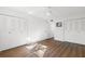 Bedroom featuring spacious closets, modern ceiling fan, and wood-style flooring with lots of natural light at 831 Maple Ct # 303, Dunedin, FL 34698