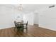 Cozy dining room with updated floors, and chandelier lighting, perfect for intimate meals and entertaining guests at 831 Maple Ct # 303, Dunedin, FL 34698