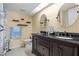 Bathroom featuring a double vanity with dark wood cabinets, granite countertop, and marine themed decor at 1033 Bowsprit Ln # 1406, Holiday, FL 34691