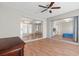 Bedroom with sliding glass doors and ceiling fan with wood-look vinyl floors throughout at 1033 Bowsprit Ln # 1406, Holiday, FL 34691