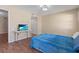 Bright bedroom featuring wood-look flooring, a TV, and a closet for ample storage space and convenience at 1033 Bowsprit Ln # 1406, Holiday, FL 34691