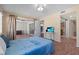 Spacious bedroom with wood-look flooring, access to balcony, TV, closet and bathroom, creating a serene retreat at 1033 Bowsprit Ln # 1406, Holiday, FL 34691