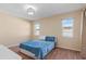 Comfortable bedroom with wood-look flooring and two windows providing natural light, furnished with a bed at 1033 Bowsprit Ln # 1406, Holiday, FL 34691