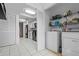 Convenient laundry area with a washer, dryer, and storage shelves located adjacent to the kitchen at 1033 Bowsprit Ln # 1406, Holiday, FL 34691