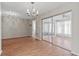 Bright living room with sliding doors to the lanai, showcasing a chandelier at 1033 Bowsprit Ln # 1406, Holiday, FL 34691