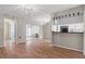 Open living space with wood flooring and sliding glass doors leading to the lanai at 1033 Bowsprit Ln # 1406, Holiday, FL 34691