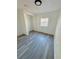 Clean bedroom with window and wood-look flooring at 1833 Knollwood Dr, Holiday, FL 34690