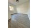 Clean bedroom with natural light and wood-look flooring at 1833 Knollwood Dr, Holiday, FL 34690