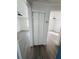 Bright hallway featuring modern flooring and access to multiple rooms with ceiling fans at 1833 Knollwood Dr, Holiday, FL 34690