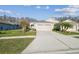Inviting home with manicured lawn, charming front yard, and a spacious driveway at 2932 Tanglewylde Dr, Land O Lakes, FL 34638