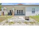 Covered patio featuring a concrete tile floor, chairs, brick pillars and an outdoor fireplace at 3611 19Th N St, St Petersburg, FL 33713