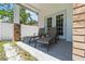 Covered patio featuring two lounge chairs, privacy fence, brick pillars and dual access doors at 3611 19Th N St, St Petersburg, FL 33713