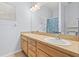 Bright bathroom features a double sink vanity, large mirror, and a blue-patterned shower curtain at 3611 19Th N St, St Petersburg, FL 33713