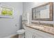 Light-filled bathroom with granite vanity, updated fixtures, and a toilet with built-in storage at 3611 19Th N St, St Petersburg, FL 33713