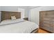 Comfortable bedroom features wood-look bedframe, hardwood floors, closet and dresser at 3611 19Th N St, St Petersburg, FL 33713