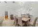 Open-concept dining area featuring a wooden table, upholstered chairs, and modern pendant lighting at 3611 19Th N St, St Petersburg, FL 33713