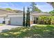 Charming single-story home featuring an attached garage, blue entry door, and well-manicured front lawn at 3611 19Th N St, St Petersburg, FL 33713