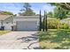 Charming single-story home featuring an attached garage, blue entry door, and well-manicured front lawn at 3611 19Th N St, St Petersburg, FL 33713