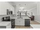 Modern kitchen featuring white cabinets, stainless steel appliances, and an open layout to the living room at 3611 19Th N St, St Petersburg, FL 33713