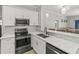 Modern kitchen with stainless steel appliances, white cabinets and pendant lights at 3611 19Th N St, St Petersburg, FL 33713