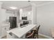 Well-lit kitchen with white cabinets, stainless steel appliances, counter seating, and pendant lighting at 3611 19Th N St, St Petersburg, FL 33713