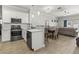 Stylish kitchen with white cabinets, stainless steel appliances, and an open view to the living area at 3611 19Th N St, St Petersburg, FL 33713