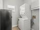 A compact laundry room with a stacked washer and dryer unit and a nearby fridge at 3611 19Th N St, St Petersburg, FL 33713