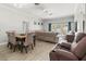 Open-concept living and dining area with tile flooring, neutral décor, and sliding glass doors at 3611 19Th N St, St Petersburg, FL 33713