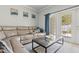 Cozy living room with a plush beige sofa, glass coffee table, and a sliding glass door leading to the outdoors at 3611 19Th N St, St Petersburg, FL 33713