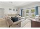 A comfortably furnished living room featuring a large leather sectional sofa and access to the outdoor patio at 3611 19Th N St, St Petersburg, FL 33713