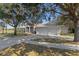 Charming single-story home featuring a spacious three-car garage and covered front porch in a serene, park-like setting at 456 Diamond Dr, Spring Hill, FL 34609