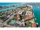 Panoramic aerial view of condos with easy access to waterway, tennis courts, lush landscaping, and ample parking at 8711 Blind Pass Rd # 307A, St Pete Beach, FL 33706