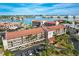 Beautiful aerial view of waterfront condo community, lush landscaping, and convenient parking at 8711 Blind Pass Rd # 307A, St Pete Beach, FL 33706